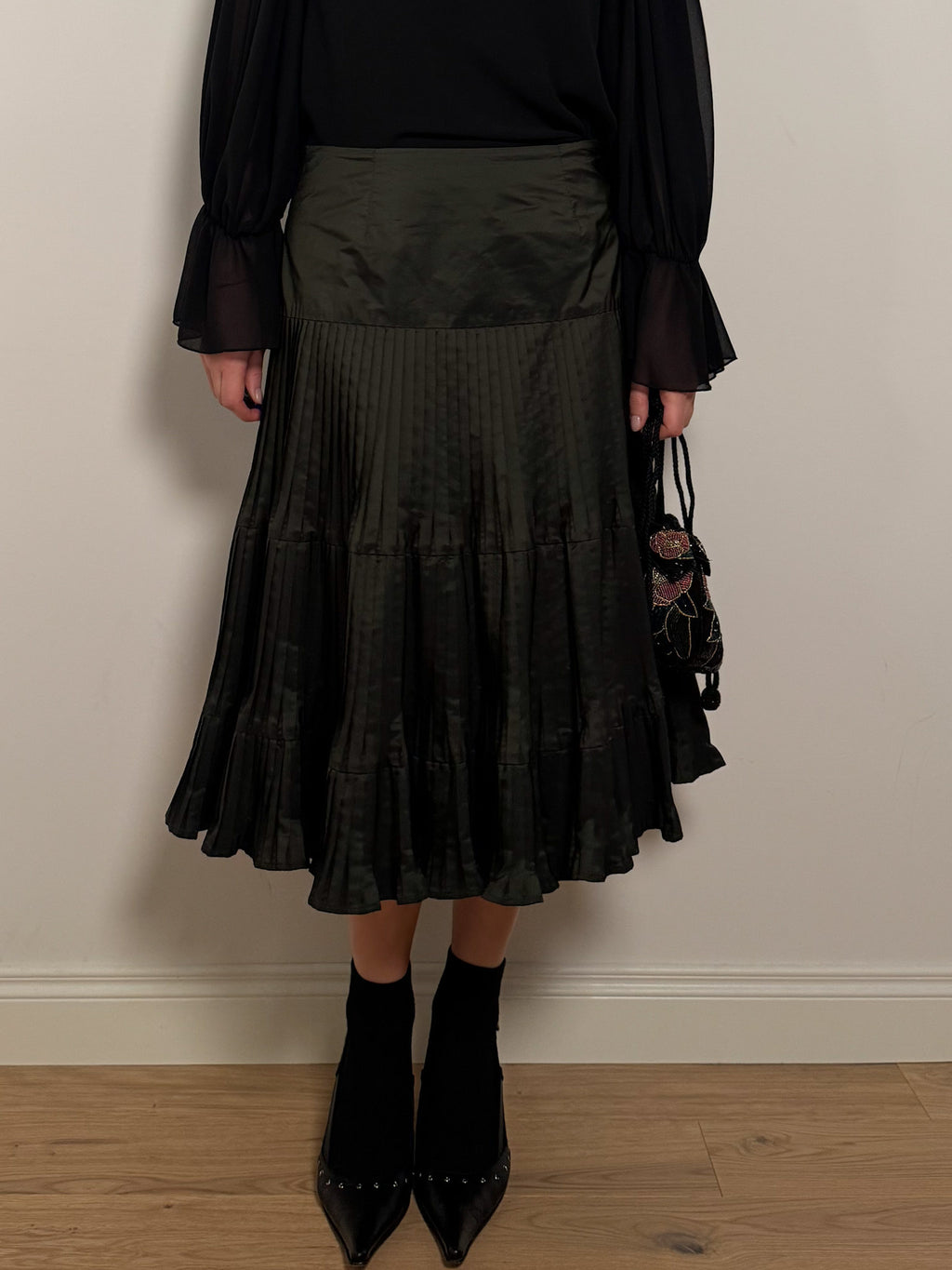 Pleated dark green skirt