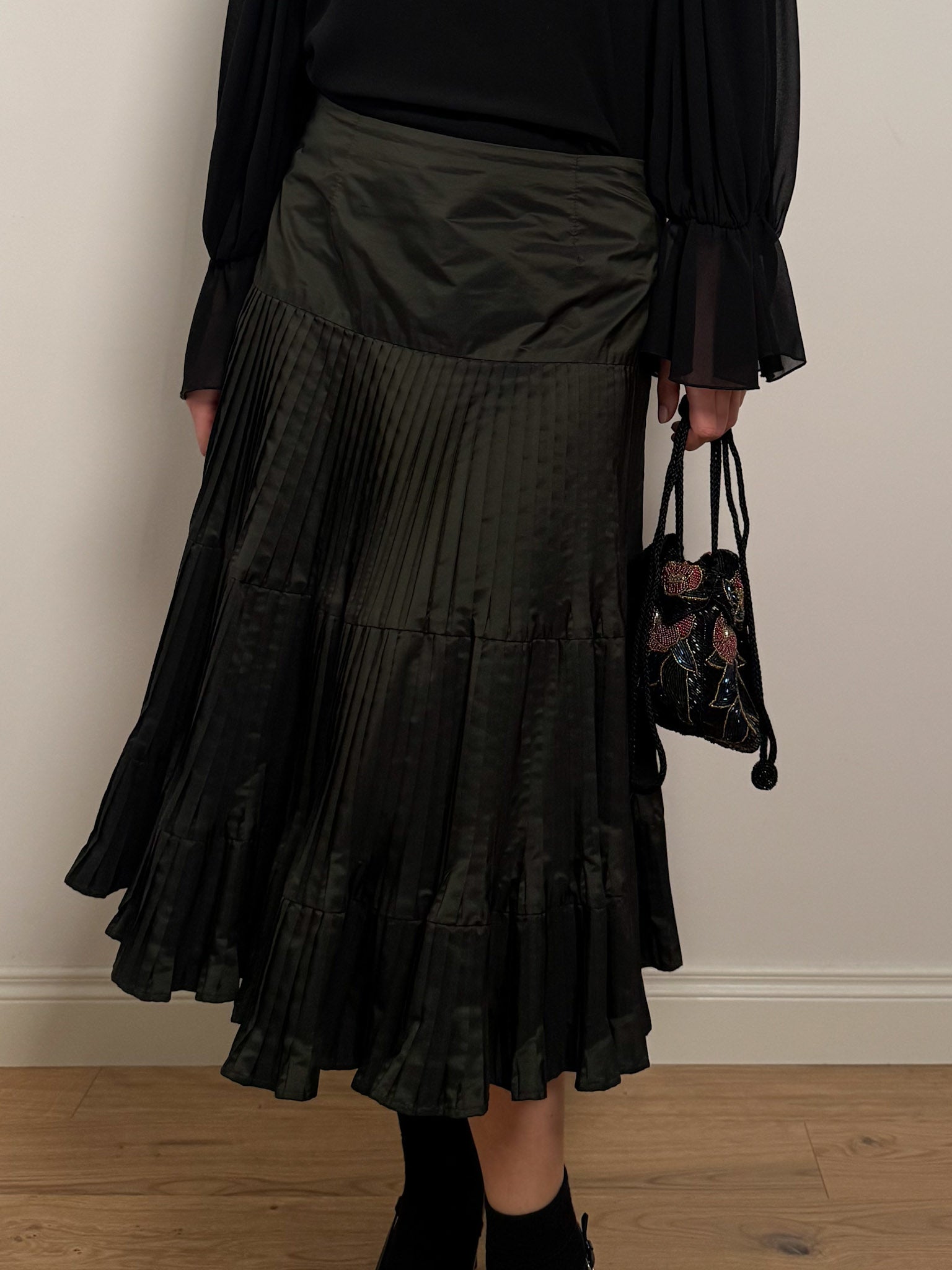 Pleated dark green skirt