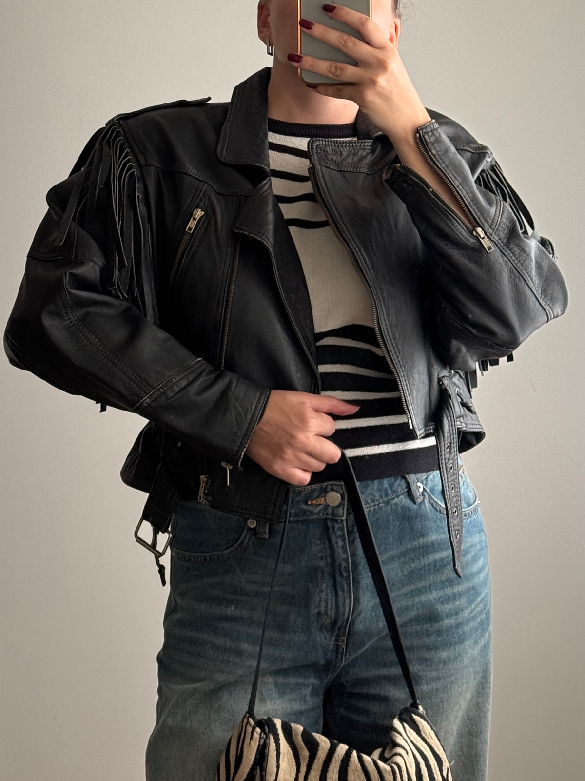 Chiodo nero in vera pelle con frange